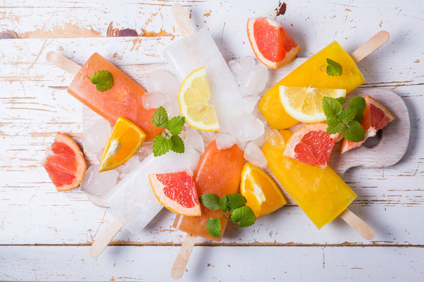 Colorful popsicles on rustic wood background - Foto, afbeelding
