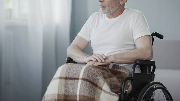 Ill senior person sitting in wheelchair, thinking about life, man needs support - Photo, Image