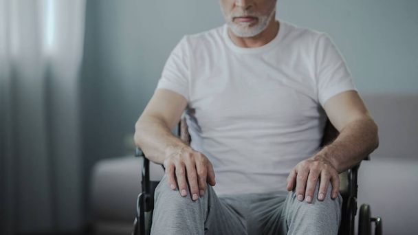 Male sitting in wheelchair, thinking about his life at rehabilitation center - Fotoğraf, Görsel