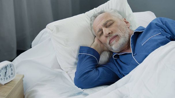 Closeup of retired man sleeping in bed in the morning, recovery time, health - Foto, Imagem
