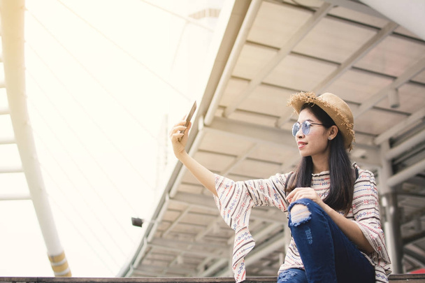 Asian woman tourist using smartphone selfie during travel in Bangkok, Relax time on vacation hipster life - Photo, image