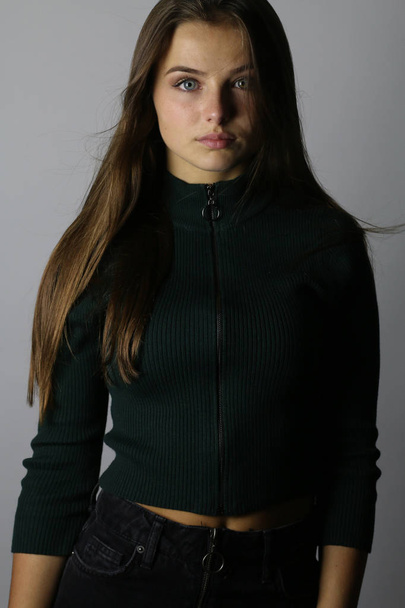 Beautiful fashion teen posing on a gray background  - Photo, Image