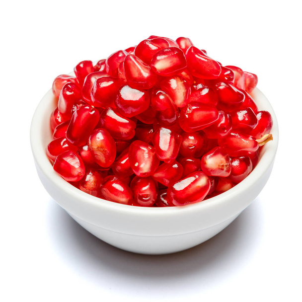 Pomegranate seeds in ceramic bowl close-up - Photo, Image