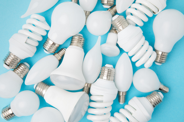 top view of different white lamps isolated on blue - Foto, immagini