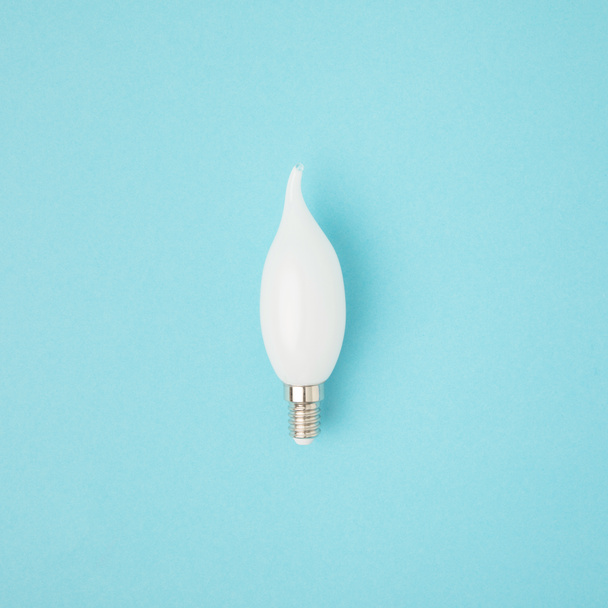 close up view of white light bulb isolated on blue - Zdjęcie, obraz