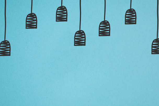 close up view of drawn black lamp holders isolated on blue - Photo, Image