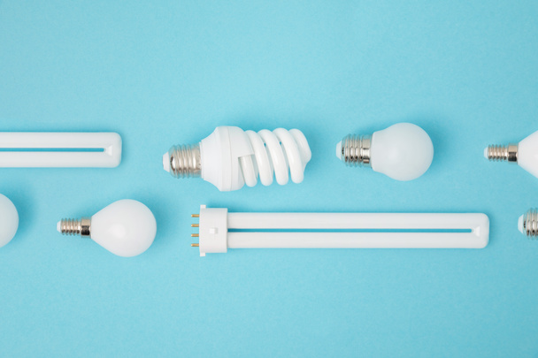 flat lay with arranged various light bulbs isolated on blue - Photo, Image