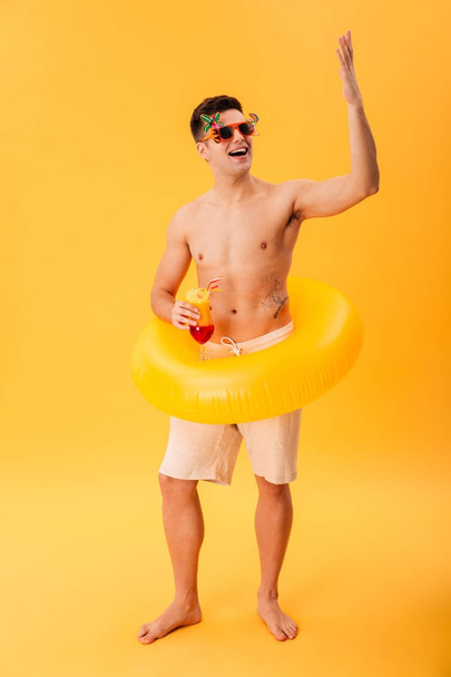 Full-length image of Happy naked man in shorts, unusual sunglasses - Foto, imagen