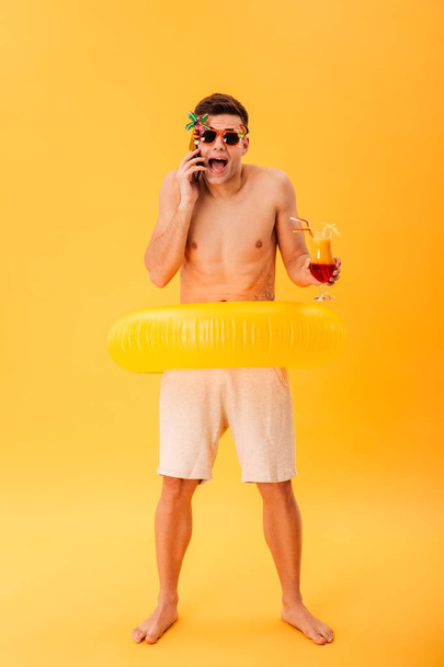 Full-length image of Screaming naked man in shorts and sunglasses - Fotografie, Obrázek
