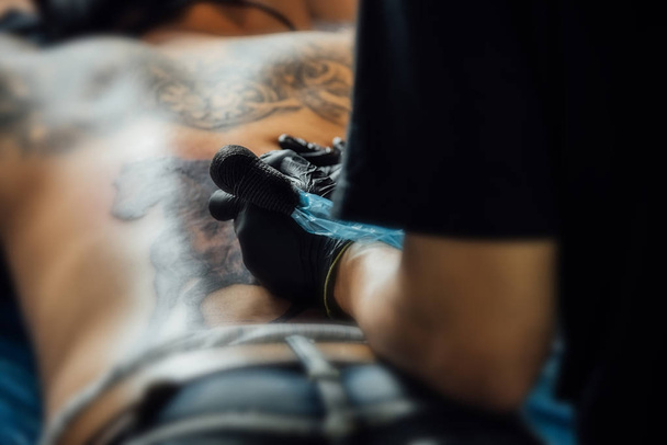 Tattoo artist drawing art on body - Fotoğraf, Görsel