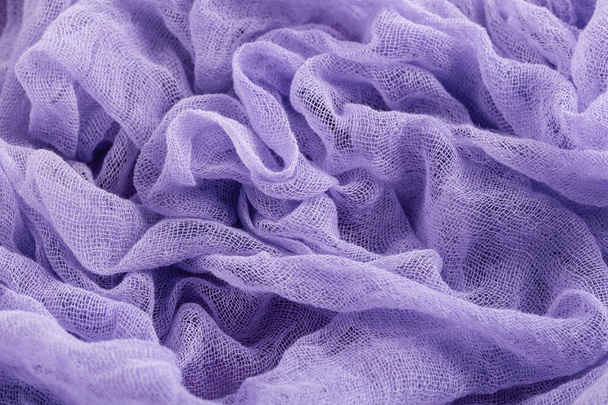Closeup of hand dyed gauze fabric purple color. Ultra violet tre - Foto, imagen