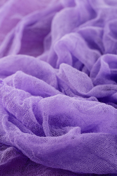 Closeup of hand dyed gauze fabric purple color. Ultra violet tre - Фото, изображение