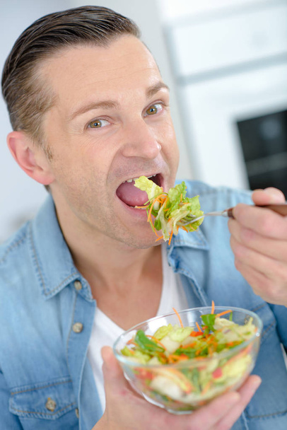 middle aged man eating a healthy meal - 写真・画像