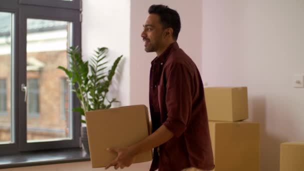 happy man with box moving to new home and dancing - Filmmaterial, Video