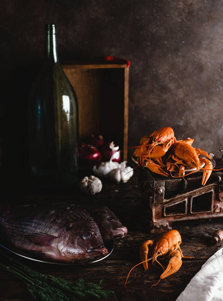 close-up view of fresh raw fish and lobsters on vintage scales  - Fotografie, Obrázek