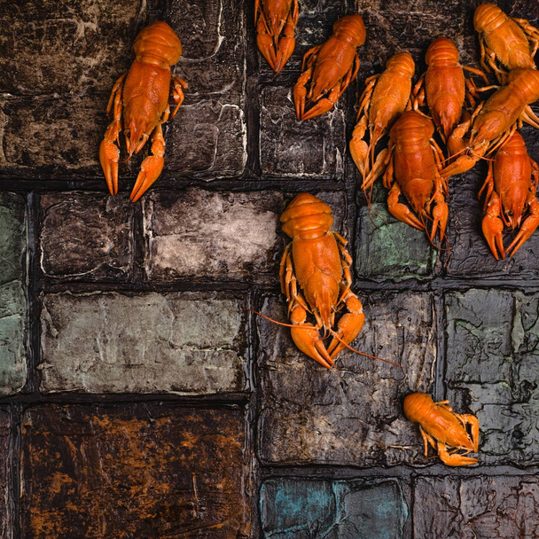 top view of gourmet lobsters on brick wall surface  - Фото, зображення