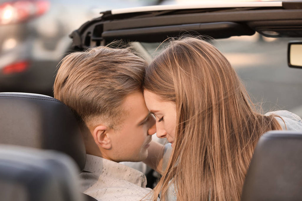 Happy young couple in modern car - Фото, изображение