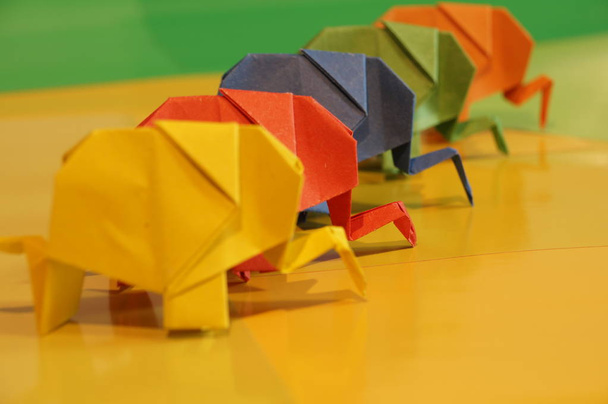Des éléphants en origami. Éléphants en papier coloré sur un fond multicolore. Art japonais
. - Photo, image