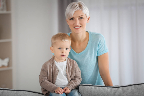Attractive young mother with her baby at home - Foto, Bild