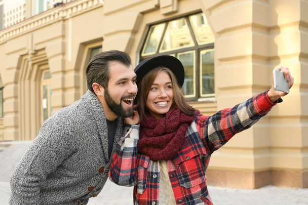 Young adorable couple taking selfie outdoors - Zdjęcie, obraz