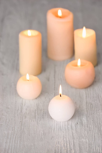 Burning candles on wooden table - Valokuva, kuva