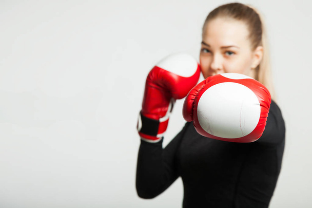 girl with the red boxing gloves, black background with copy space - Foto, Imagem