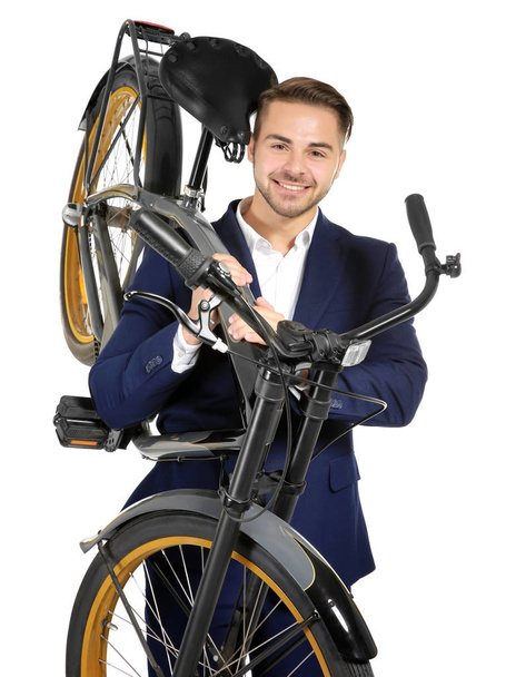 Young handsome businessman holding bicycle on white background - Фото, зображення
