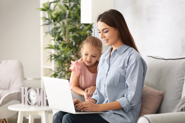 Busy young woman with daughter in home office - Photo, Image