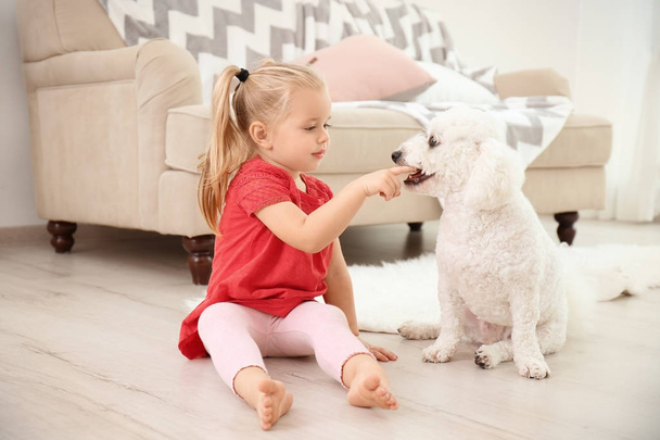 Adorable little girl with her dog at home - Zdjęcie, obraz