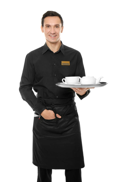 Waiter holding tray with tea set on white background - Photo, Image