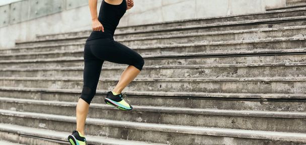 Young fitness sporty woman running upstairs - Valokuva, kuva