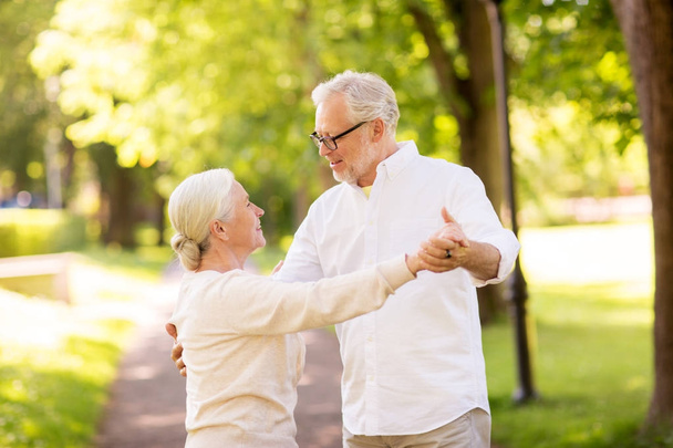 happy senior couple dancing at summer park - Foto, Bild