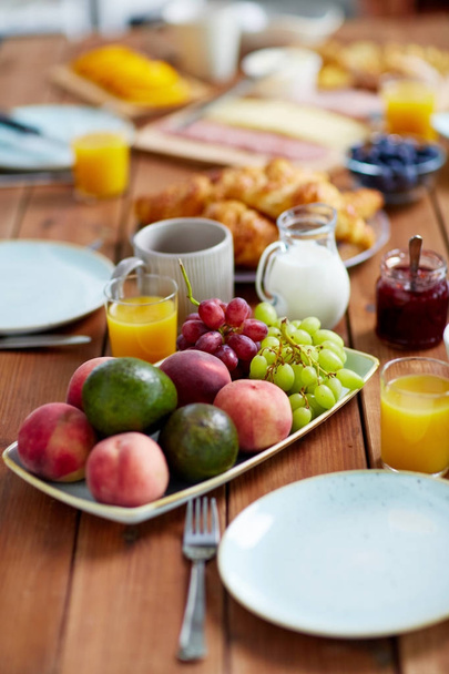 fruits, juice and other food on table at breakfast - Φωτογραφία, εικόνα