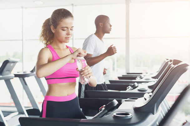 Man and woman, couple in gym on treadmills - Фото, зображення