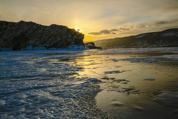 Pattern on ice of lake Baikal during sunset. Siberia Russia - 写真・画像