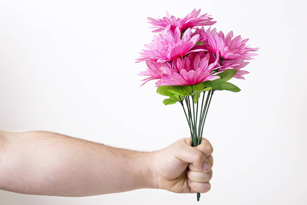 Handing off bouquet of fake flowers - Foto, Imagen