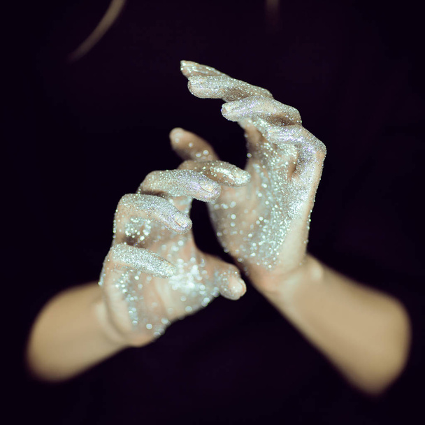 Beautiful woman hands with glister, glitter or fairy dust close up - Foto, Bild