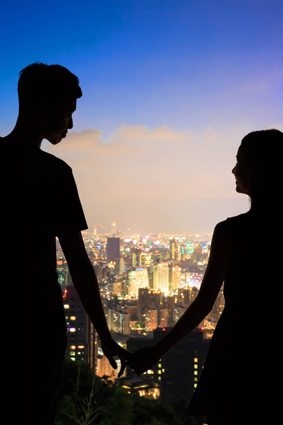silhouette of couple with night taipei city panorama in the taiwan - Fotó, kép