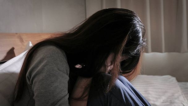 woman feeling  depressed and sitting  on the bed - Фото, зображення