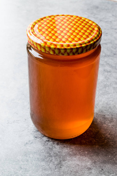Honey in Jar with Lid. Copy Space. - Zdjęcie, obraz