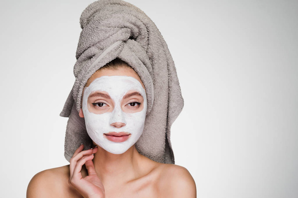 girl with a towel on her head applied a face mask - Foto, Imagem