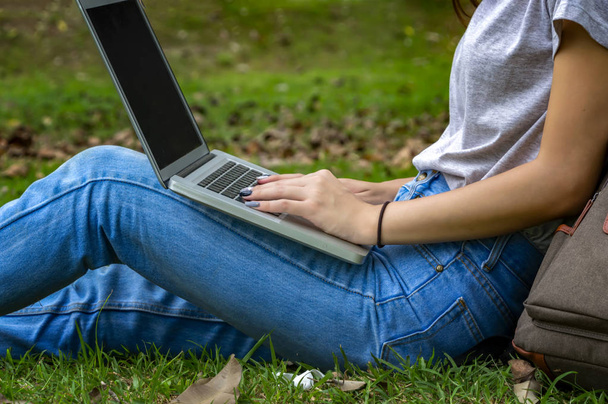Beautiful woman of a student sitting with laptop and relaxing in - Photo, Image