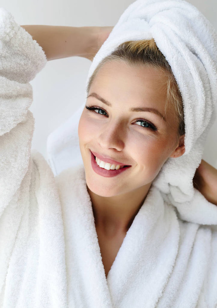 Close up portrait of happy Stunning smiling woman in bathrobe enjoying wellness weekend.picture of beautiful woman with perfect skin in spa salon.Morning lifestyle. - Photo, image