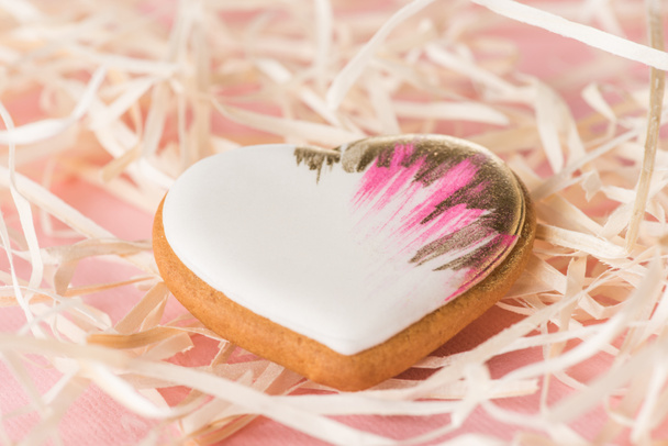 close up view of sweet heart shaped cookie and decorative straw on pink, st valentines holiday concept - Photo, Image