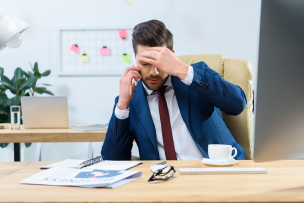 tired businessman talking by smartphone and having headache - Foto, Imagem