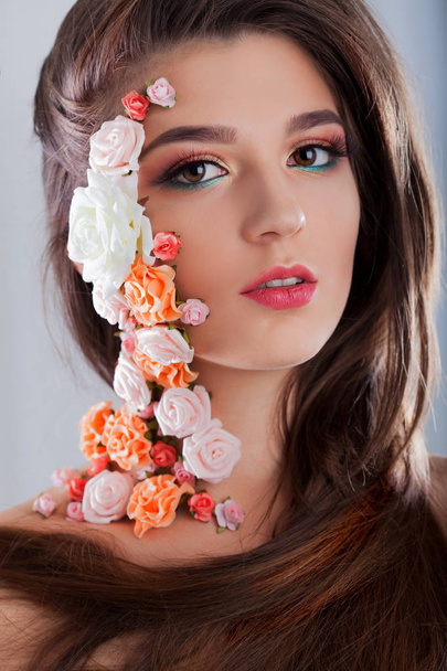 Beautiful young girl with applique flowers on the face. - Φωτογραφία, εικόνα