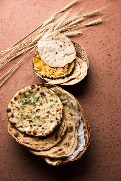 Surtido de canasta de pan indio incluye chapati, tandoori roti o naan, paratha, kulcha, fulka, missi roti
 - Foto, imagen