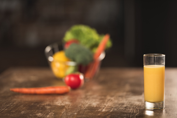 close-up view of glass of fresh orange juice on wooden table - Photo, Image