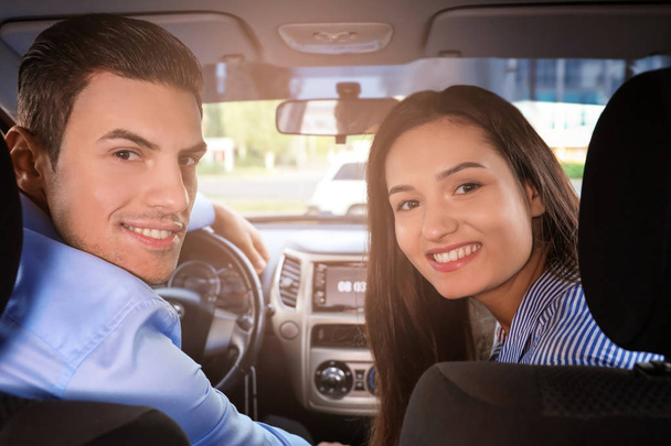 Happy young couple sitting in modern car - Foto, Imagem