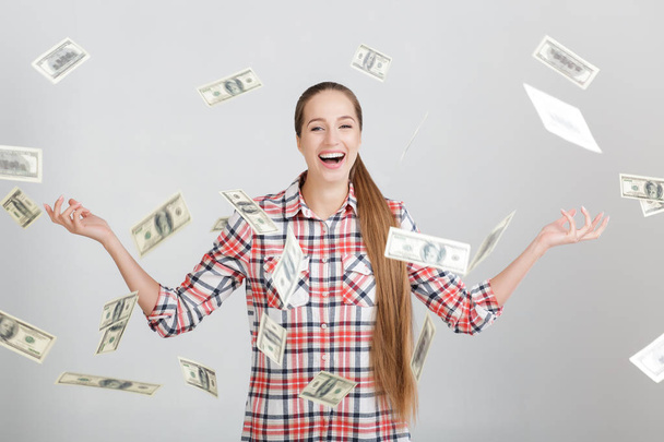 happy woman standing under money rain - Foto, afbeelding